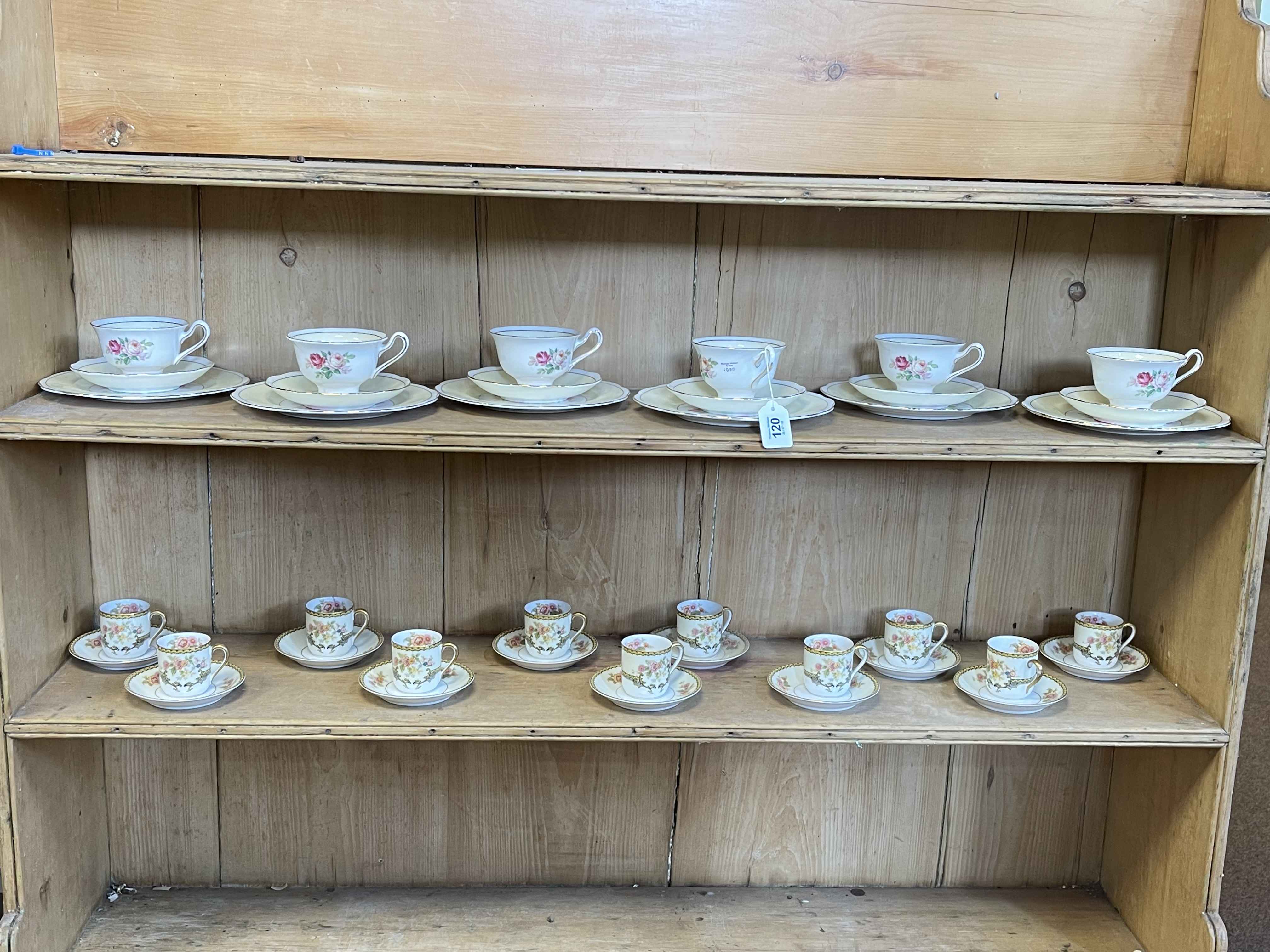 Eleven Noritake 'Aubery' coffee cans and saucers, and six Royal Albert rose decorated trios.