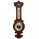Carved oak barometer-thermometer, 58cm.