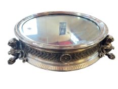 Impressive silver plated and mirror topped cakestand raised on lion mask and paw feet.