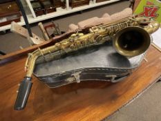 Cased saxophone and metal music stand.