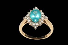 Apatite and diamond 14 carat yellow gold ring, the oval cut apatite bordered with 20 diamonds,