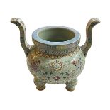 Chinese lime green ground famille rose two handled incense burner raised on three bulbous legs,