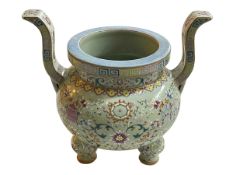 Chinese lime green ground famille rose two handled incense burner raised on three bulbous legs,