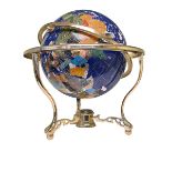 Semi-precious stone globe on brass stand.