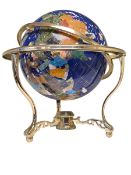 Semi-precious stone globe on brass stand.