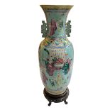 Large Chinese Famille Rose two handled vase decorate with figures on carved wood stand,