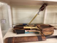 Collection of vintage tennis rackets, cricket bat, shooting stick, etc.