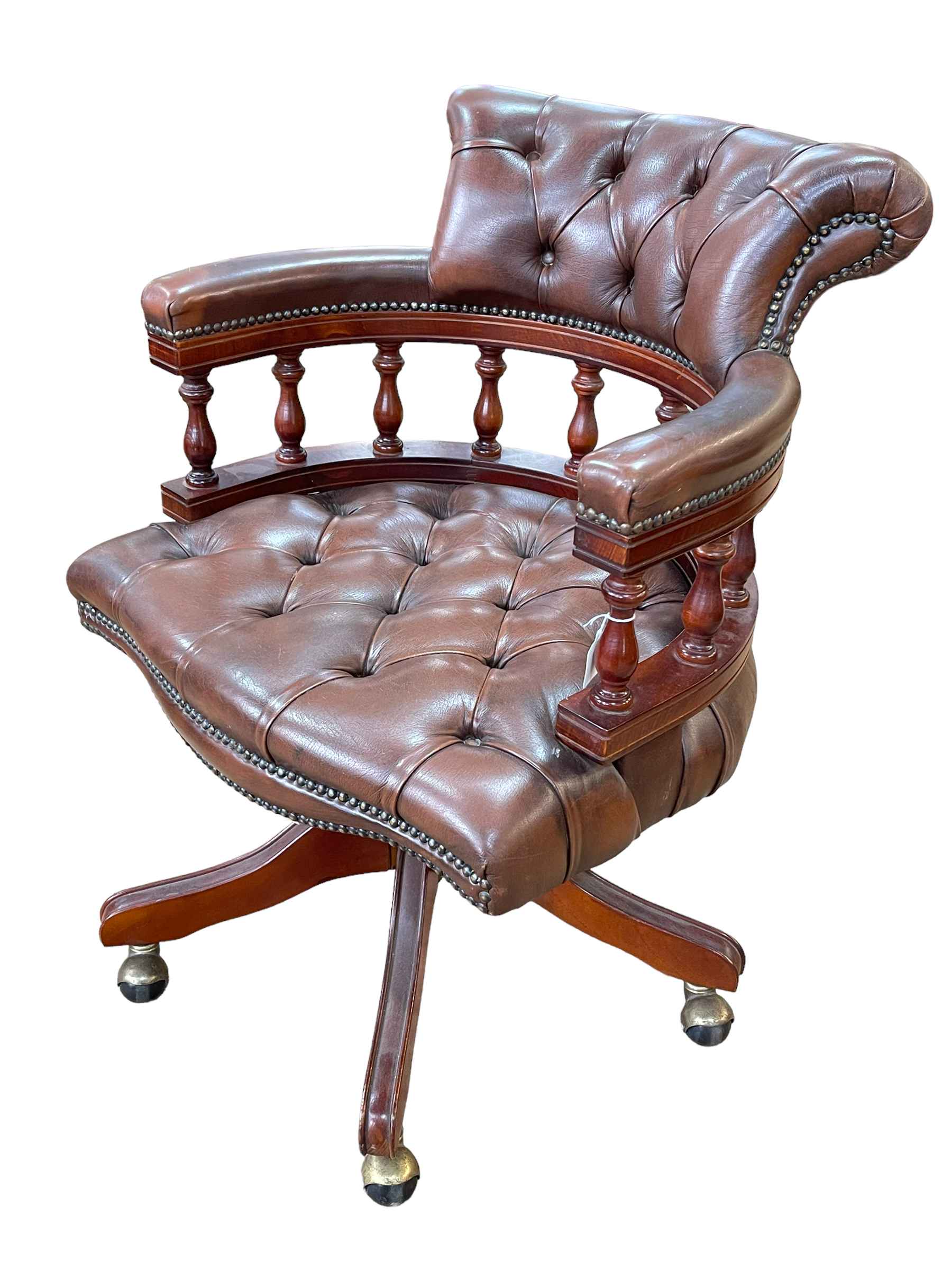 Brown buttoned leather Captains style swivel desk chair.