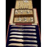 Silver five bar toast rack, silver souvenir coffee spoons, and silver handled tea knives.