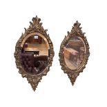 Pair oval carved giltwood bevelled wall mirrors, 70cm by 38cm.