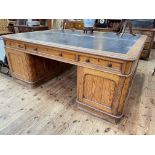 Large Victorian pitch pine partners desk having six frieze drawers and panelled cupboard doors to