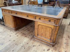 Large Victorian pitch pine partners desk having six frieze drawers and panelled cupboard doors to