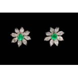 Pair emerald and diamond 18 carat gold earrings, the flower settings with eight diamond petals,