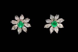 Pair emerald and diamond 18 carat gold earrings, the flower settings with eight diamond petals,