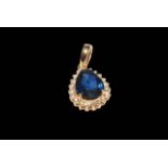 Pear shaped sapphire and diamond cluster pendant set in 18 carat yellow gold,