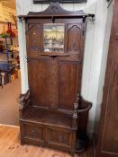 1920's carved oak hallstand with box seat, 165cm by 120cm by 37cm. (Evidence of Woodworm).