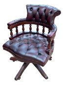 Ox blood buttoned leather Captains style swivel chair.