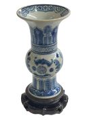 Chinese porcelain vase decorated with bats and symmetrical pattern, on wood stand, 19cm.