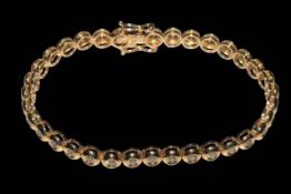 18 carat yellow gold rubover design tennis bracelet with a total of 34 round brilliant cut diamonds,