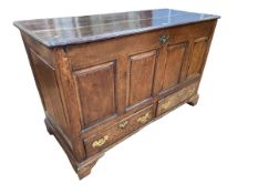 Georgian oak four panel front mule chest having two base drawers, 86cm by 138cm by 58.5cm.