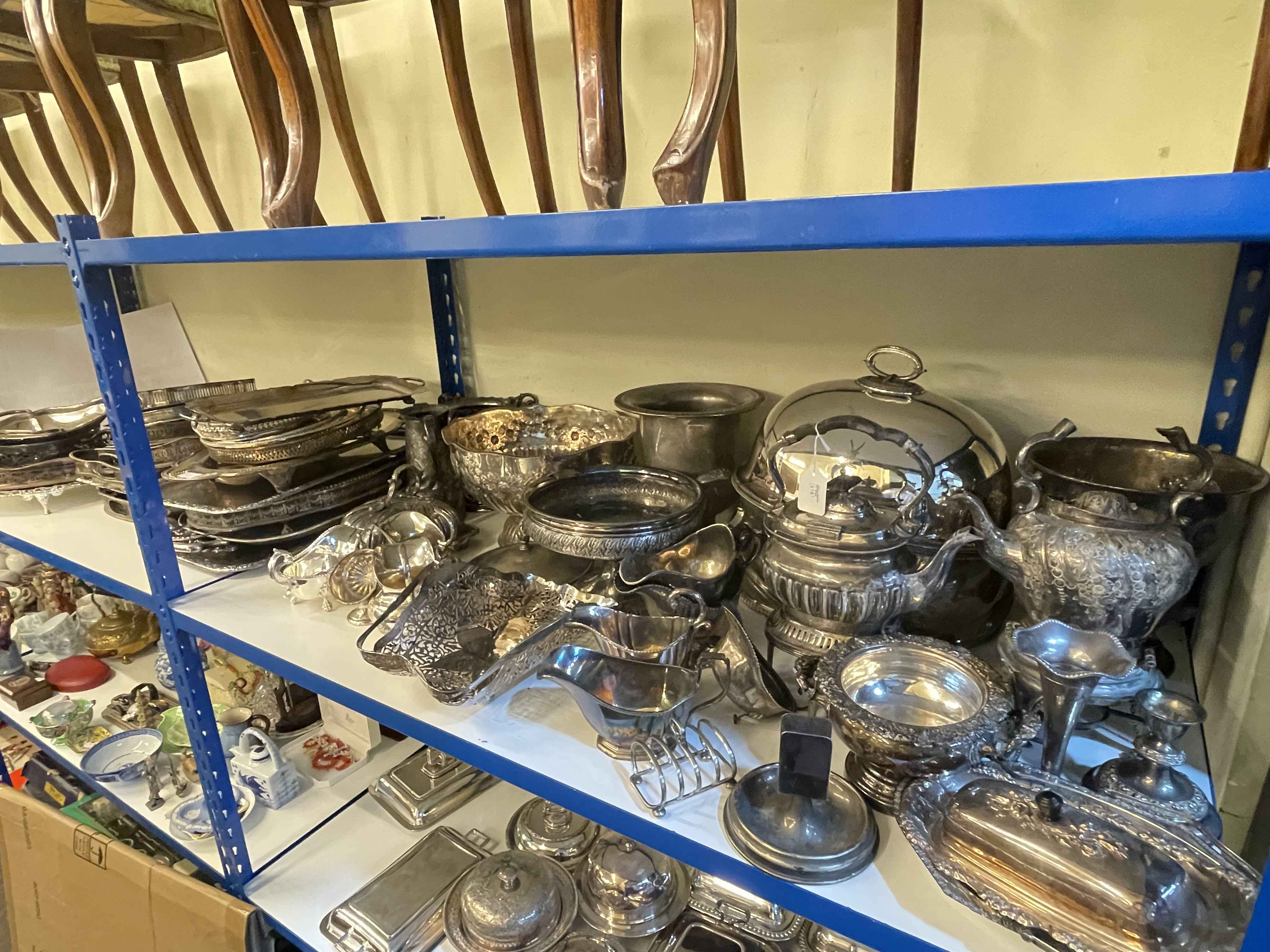 Collection of silver plated wares including punch bowl, serving trays, tureen lids, cream jugs, etc.