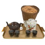 Chinese coconut teapot and four cups and Chinese teapot in wicker basket.