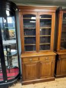 Late Victorian walnut four door cabinet bookcase, 223cm by 109cm by 44cm.