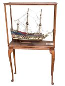 Large model of a 17th Century masted ship 'Wasa' in oak glazed case on Queen Anne legs.