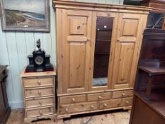 Pine combination wardrobe having central mirror panel flanked by two doors above three short and