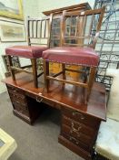 Mahogany nine drawer pedestal desk and pair antique oak side chairs, desk 77cm by 145cm by 66cm.