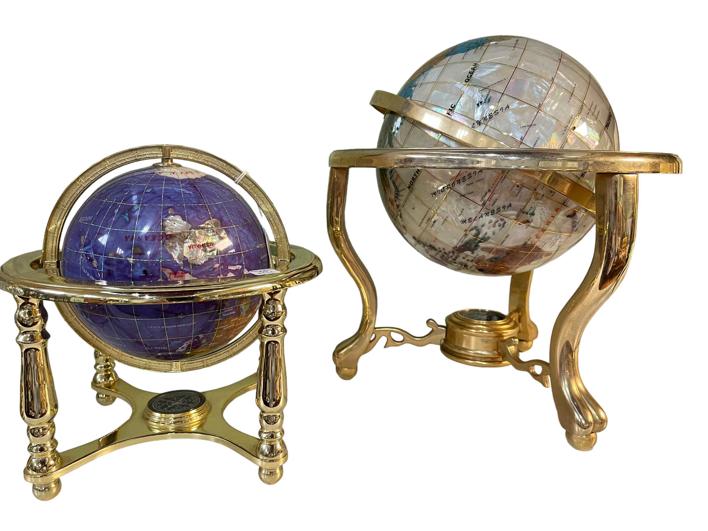 Two semi-precious stone and brass bound globes with compass bases.