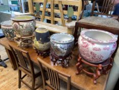 Collection of four ornate decorative fish bowls, Satsuma vase and four stands.