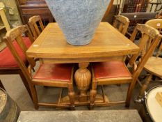 Oak draw leaf dining table and four chairs.