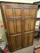 Oak linen fold panel double door wardrobe, 183cm by 125cm by 55cm.