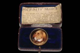 Hound miniature brooch, marked verso WB Ford 1878, 2.5cm diameter, boxed and with newspaper cutting.