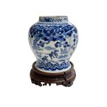Chinese porcelain blue and white vase on wood stand decorated with horses and riders in landscape,