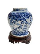 Chinese porcelain blue and white vase on wood stand decorated with horses and riders in landscape,