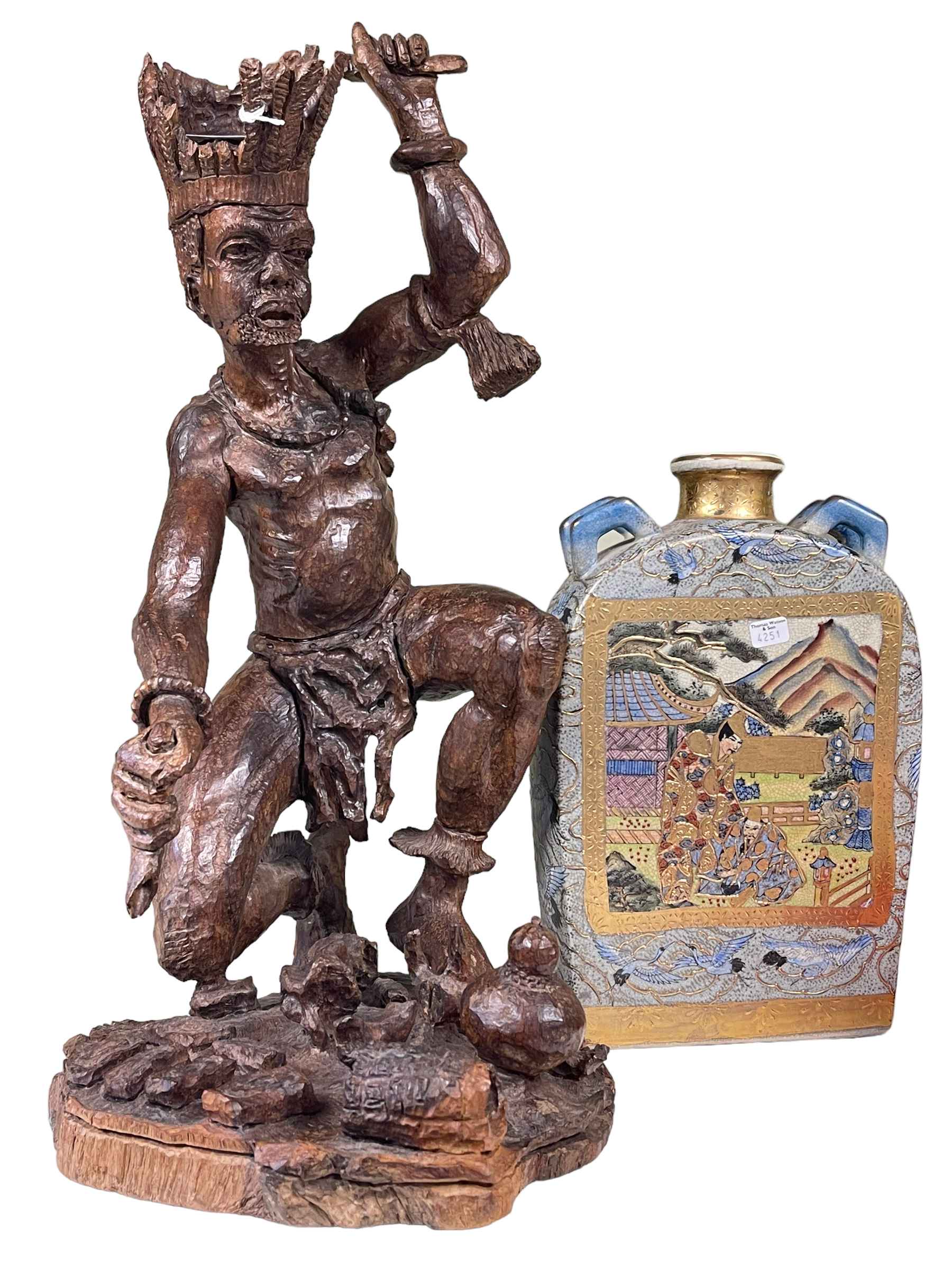 WITHDRAWN Carved tribal medicine man and a two handled Chinese jar.