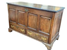 Georgian oak four panel front mule chest having two base drawers, 86cm by 138cm by 58.5cm.