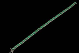 18 carat white gold, emerald and diamond bracelet containing 26 oval emeralds 7.