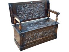Carved oak monks bench, 73cm by 104cm by 43cm (closed).