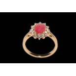 18 carat yellow gold, ruby and diamond cluster ring, the oval ruby surrounded by twelve diamonds,