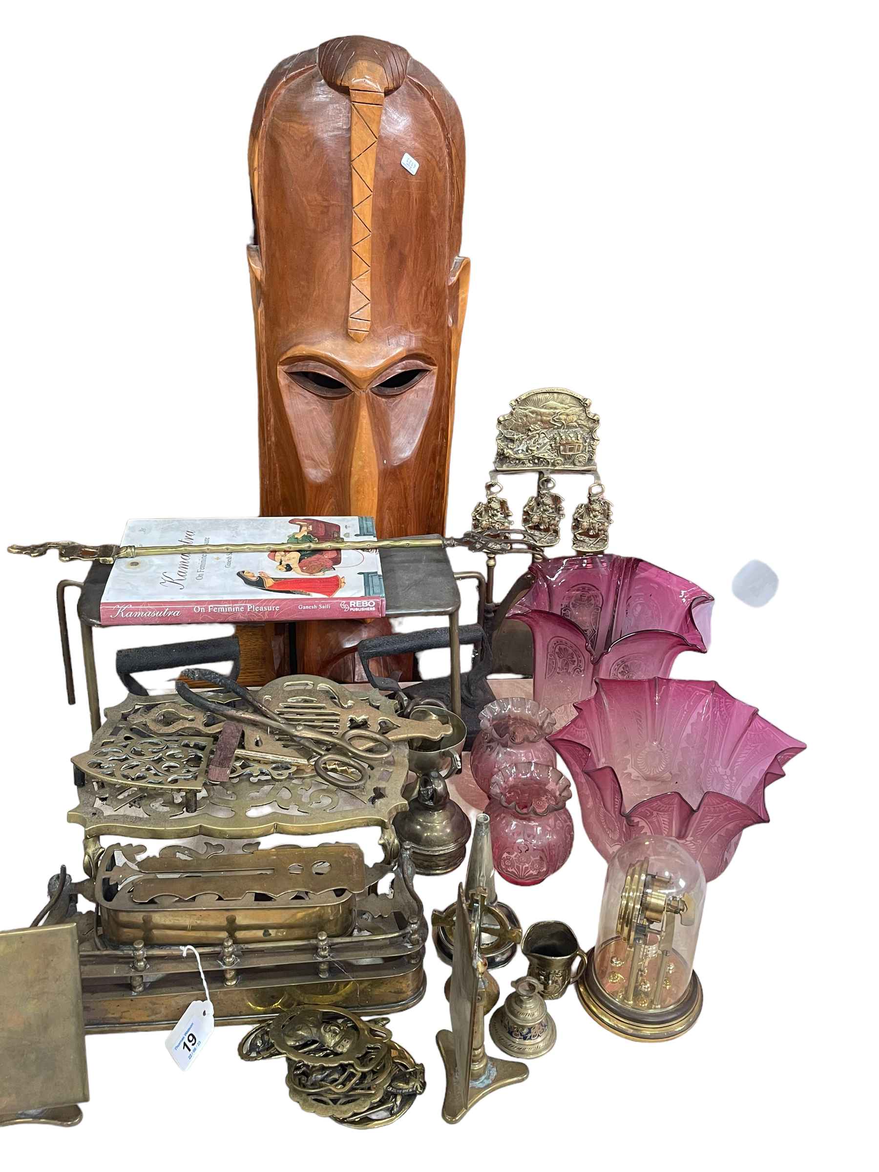 Large carved wood tribal mask, four ruby glass oil lamp shades, brass ware, etc.