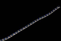 18 carat white gold, sapphire and diamond bracelet containing 26 oval sapphires 11.