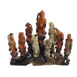 Chinese carved soapstone group of nine immortals on stand, 30cm high.