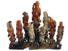 Chinese carved soapstone group of nine immortals on stand, 30cm high.