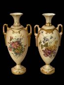 Two similar Royal Worcester vases with foliate decoration on shaded ground,