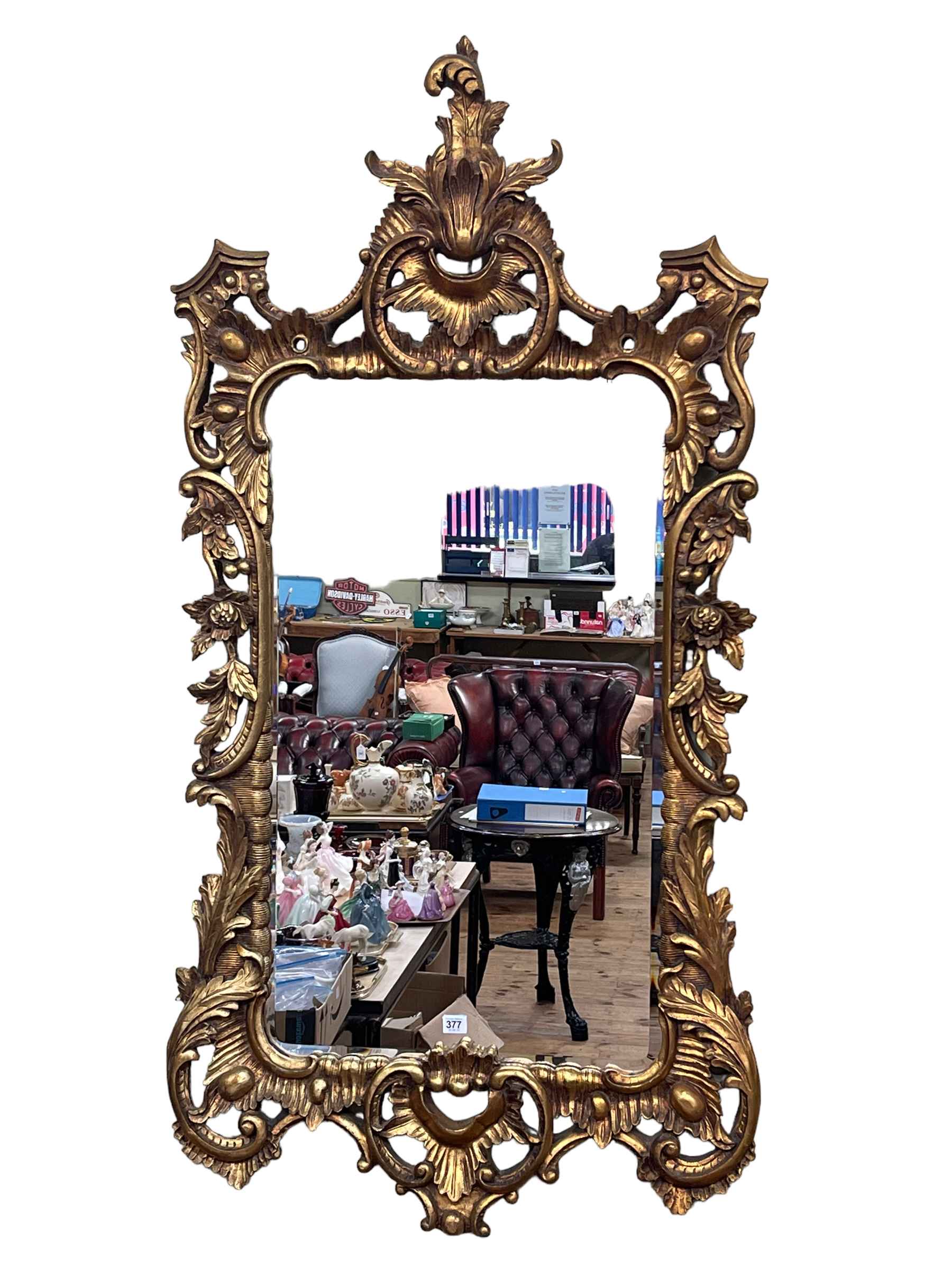 Large ornate gilt framed bevelled wall mirror, 152cm by 78cm.