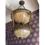 Massive centre light fitting with two tiers of lighting with winged maiden supports,