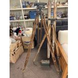 Two Theodolites on tripod stands and two vintage ranging poles.